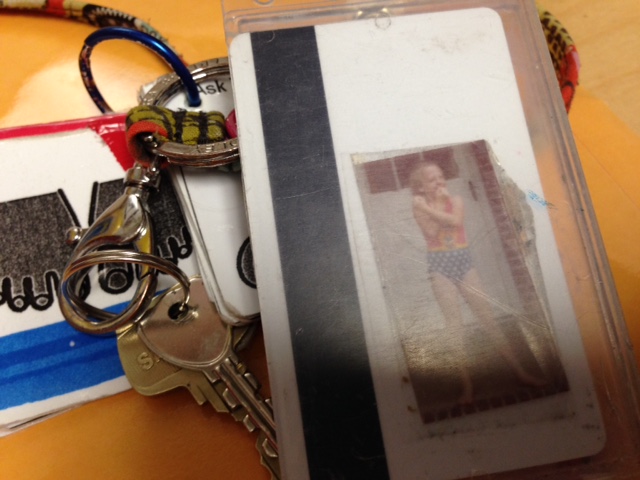 teacher's keychain with photo of her as a kid dressed as wonder woman