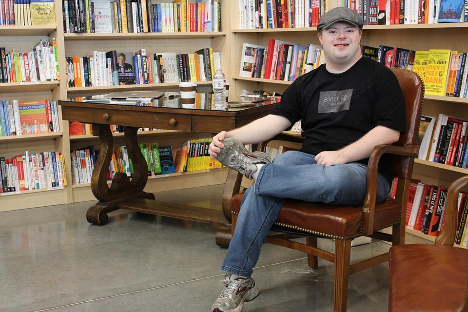 author sitting in library 