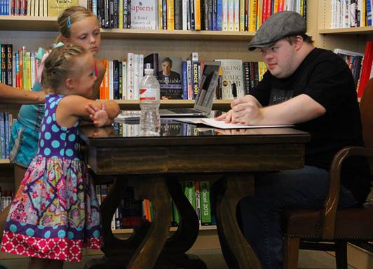 Author and children asking for autographs