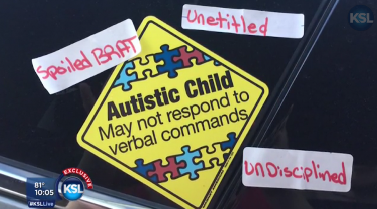 sign reads "Autistic child may not respond to verbal commands" Others have written "spoiled brat," "unentitled," "undisciplined."