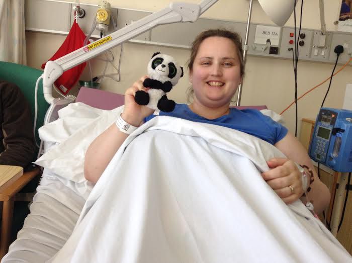 Angela in the hospital holding a stuffed panda