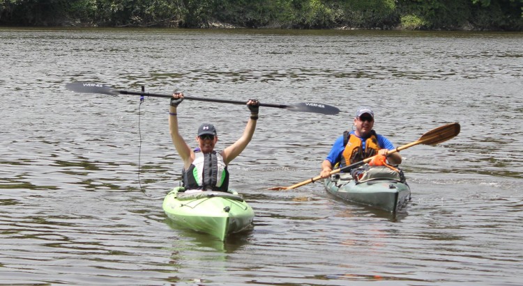 two people kayaking on river