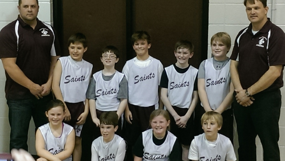 Kids' basketball team and coaches posing for a photo