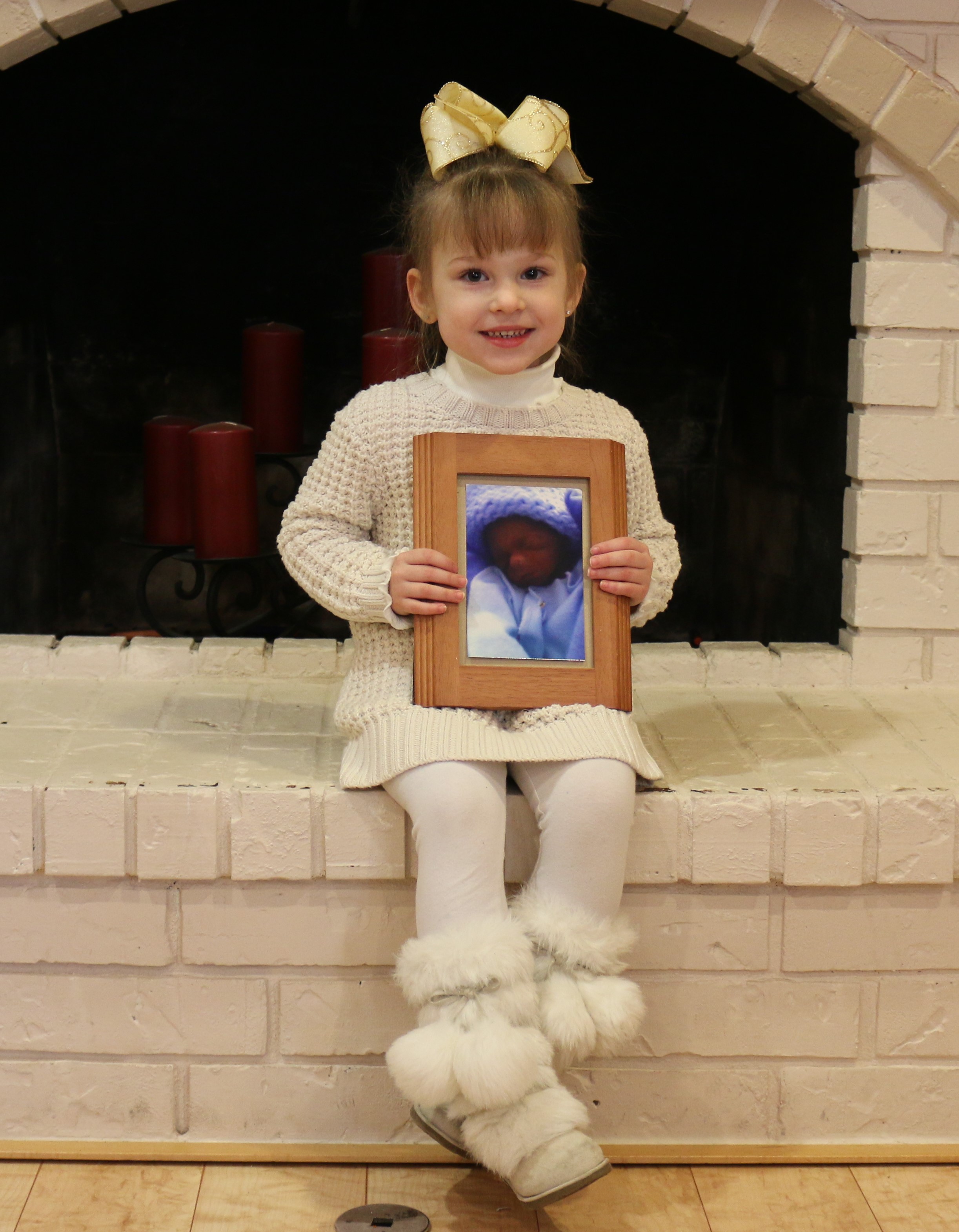 Amanda's daughter holding a picture of her brother