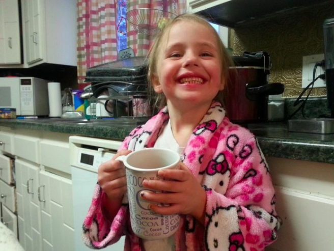 girl holding cup and smiling