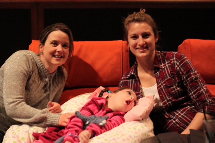two women and child on couch