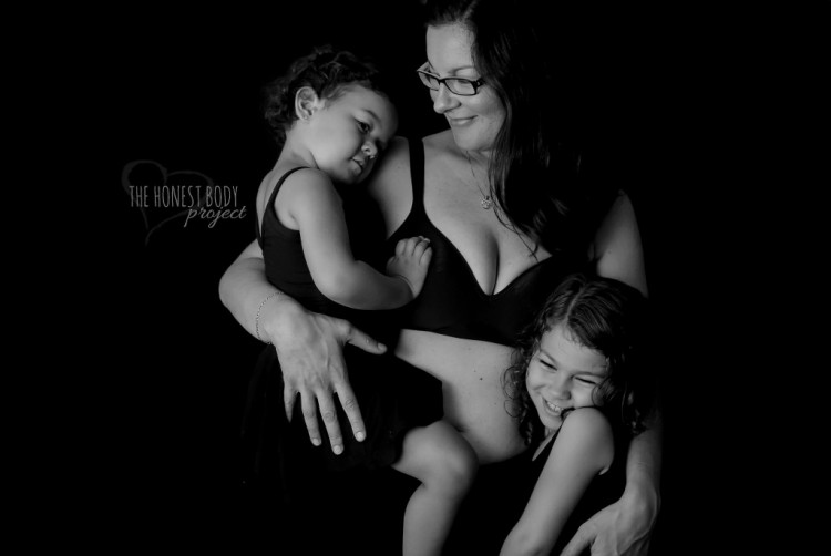 Mother smiling while holding her two children