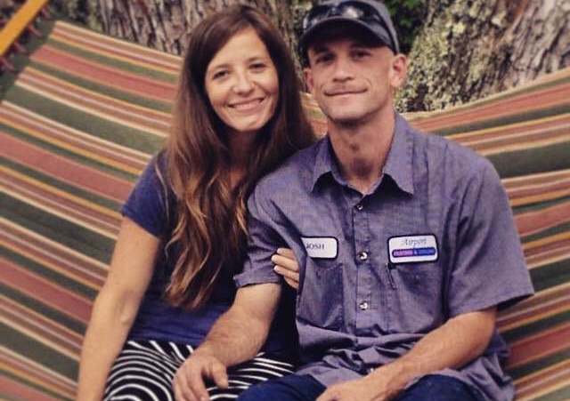 Woman and man sitting together on a hammock outdoors