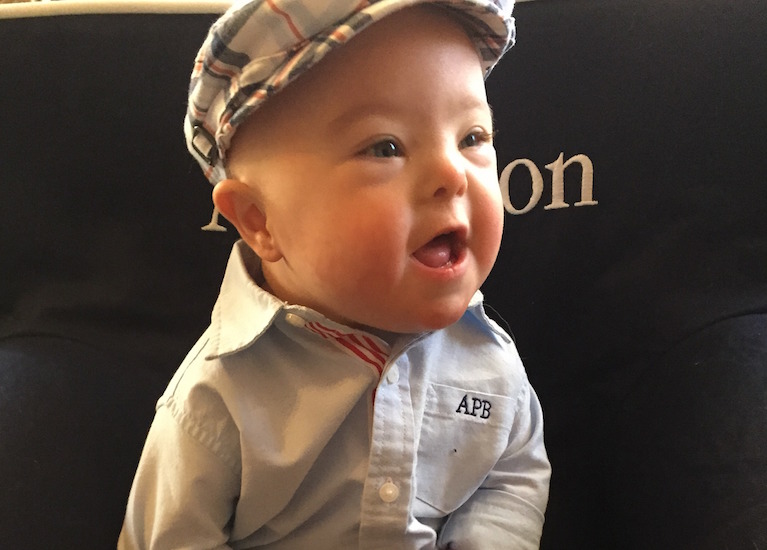 Toddler wearing a cap and button-down shirt