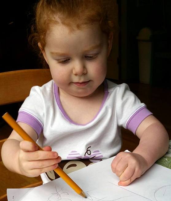 girl drawing on paper