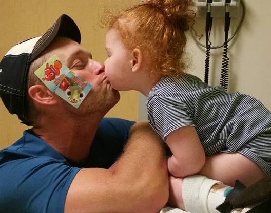 little girl kissing her dad