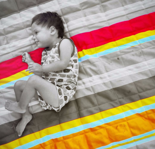 black and white photo of boy on blanket