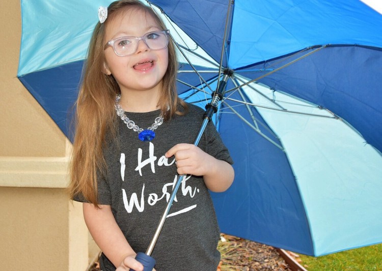 girl holding blue umbrella