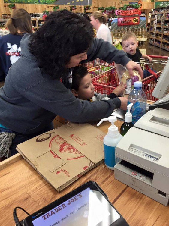 Cashier interacting with little boy. 