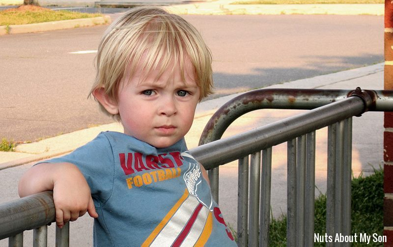 Little boy with blond hair wearing a blue t-shirt