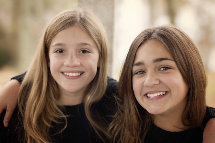 two teenage girls smiling
