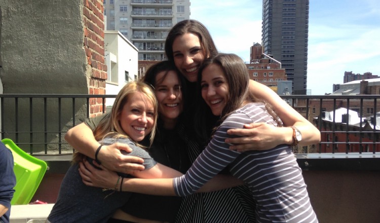 group of four girls hugging