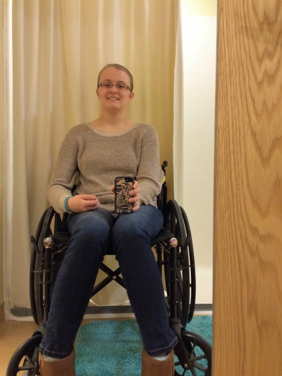 young woman smiling and sitting in wheelchair