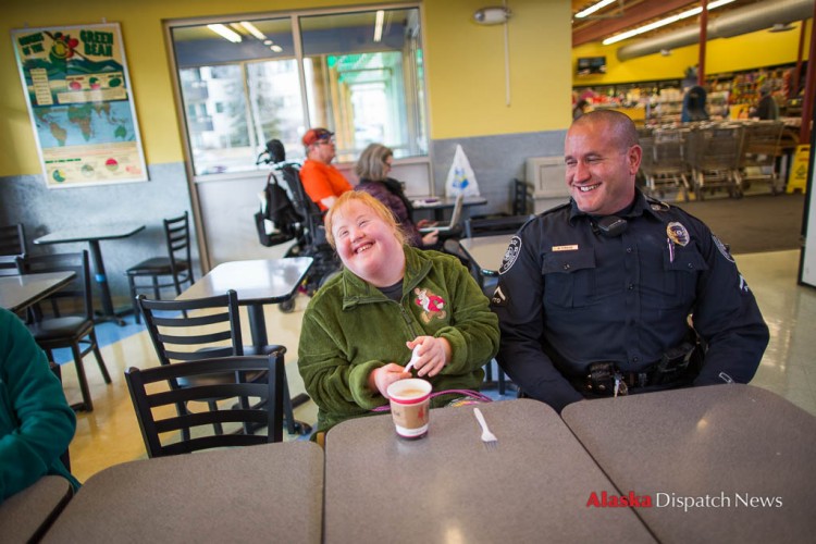 LOREN HOLMES / Alaska Dispatch News Harley Hamilton, a senior at West High living with Down syndrome and autism, meets with Anchorage police officer Matt Fraize at Sagaya City Market on Wednesday, Feb. 24, 2016. Hamilton's mother, Mallory, wanted Harley to meet a police officer so she would learn to trust them in the event they were called to a situation where they would have to interact with her.
