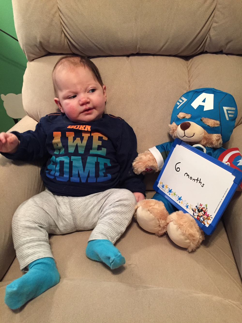 baby next to teddy bear holding "6 months" sign