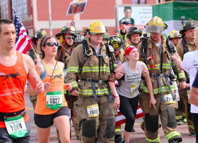 runner with cerebral palsy completes half marathon with 2 firefighters
