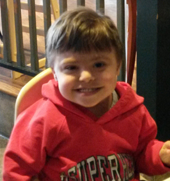 author's son in red sweatshirt, smiling