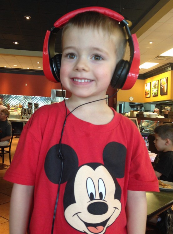boy in mickey t shirt wearing red headphones