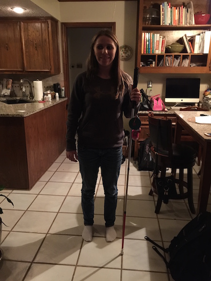 Brittany standing in the kitchen with her cane