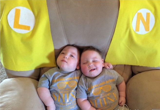 two young boys lying on a couch