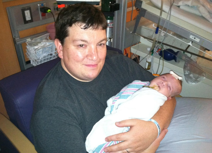 Dad holding son in the hospital