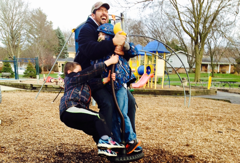 Father and son playing in a park playground