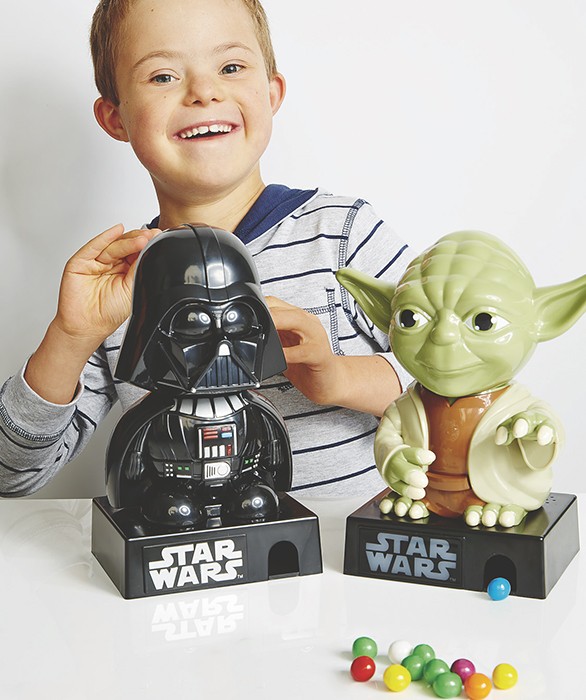 little boy with down syndrome playing with star wars toys in kmart catalog