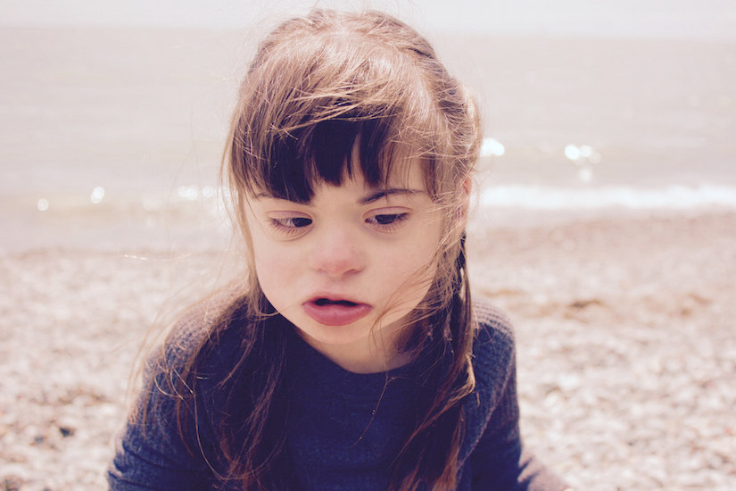 Girl on the sand near the ocean shore