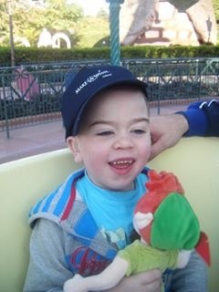 boy wearing baseball cap and smiling