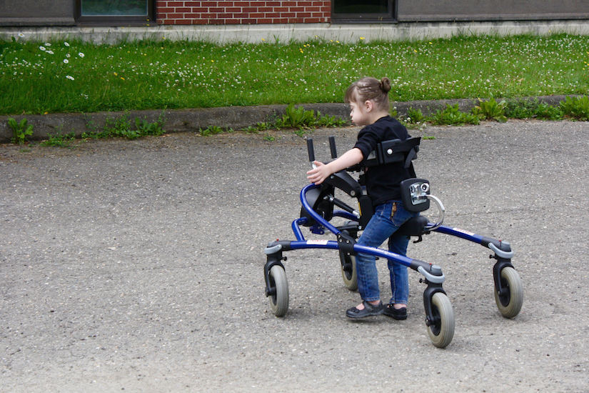 Girl using her walker outside