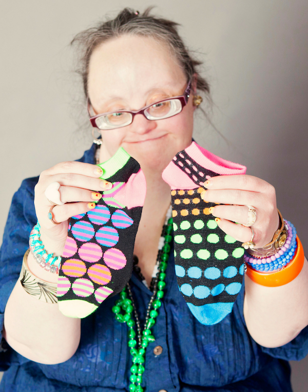 woman holding up polka dot socks