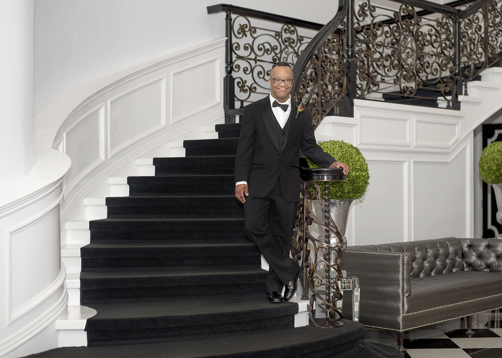 young man in tux on stairs