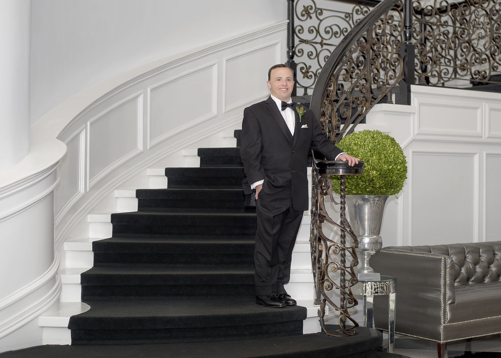 another young man in tux on stairs
