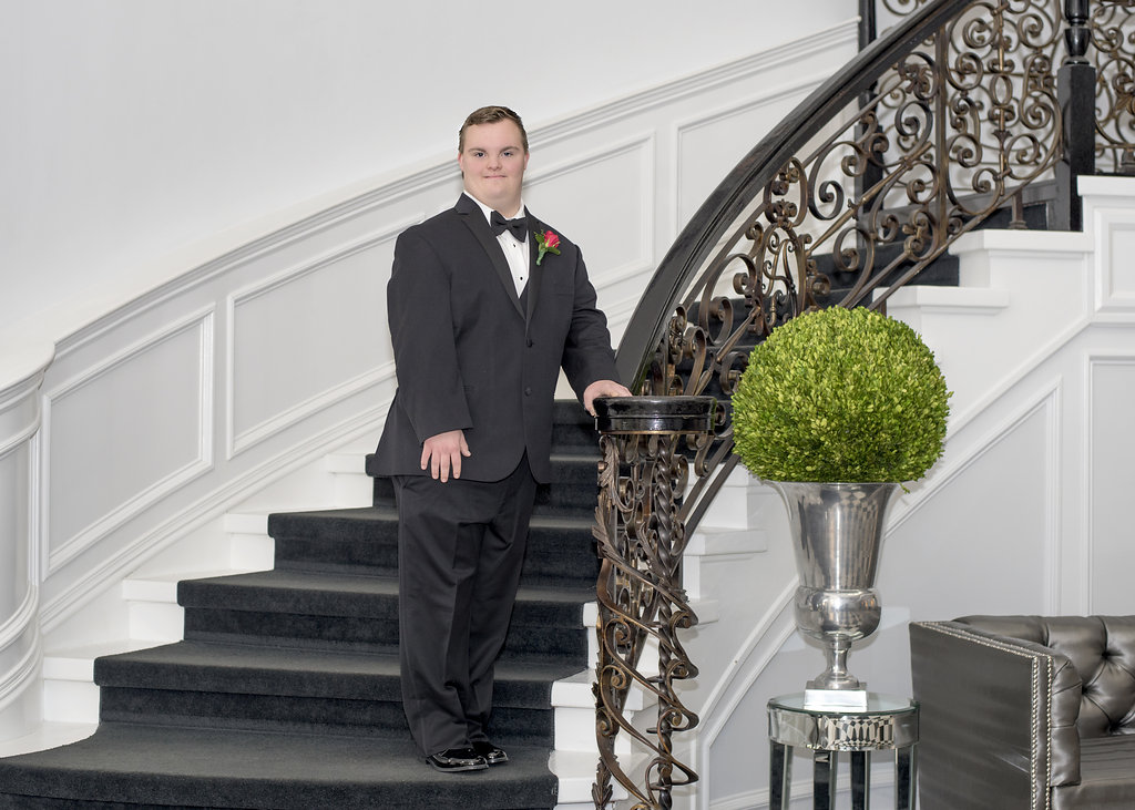 young man posing on stairs