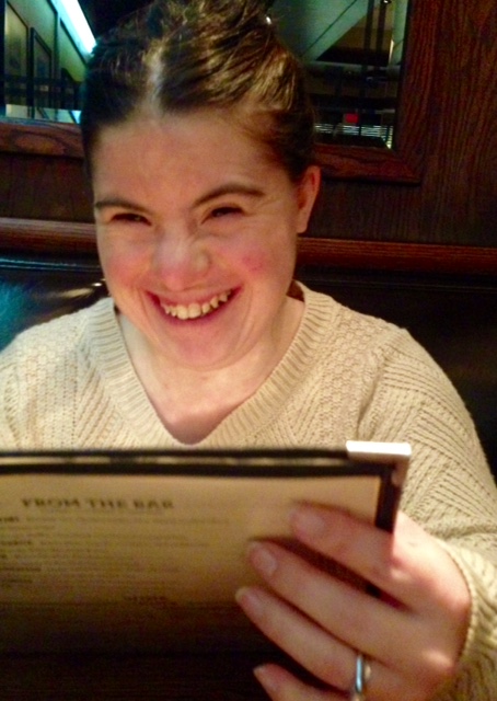 girl holding menu and smiling
