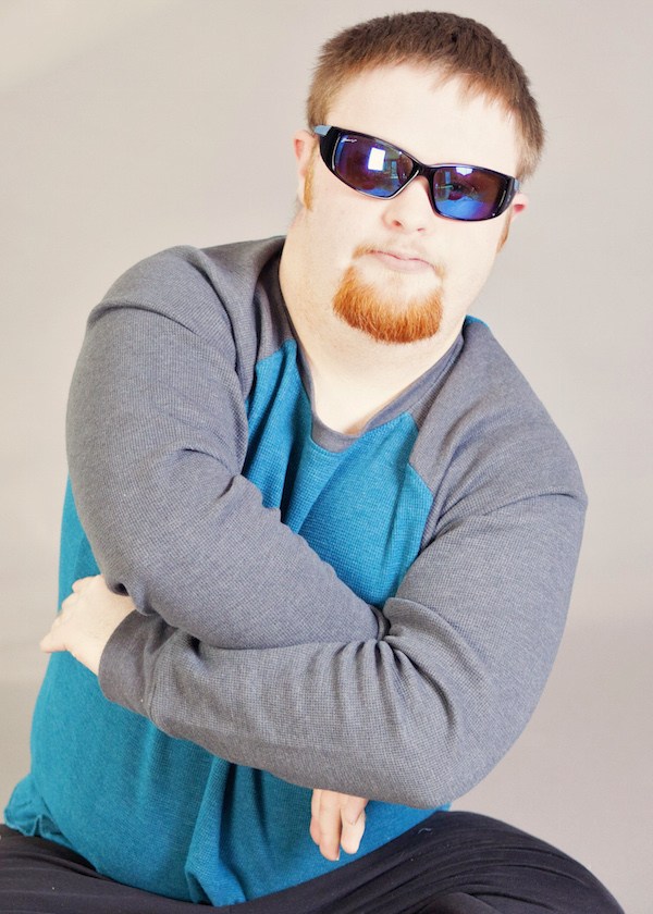 man wearing sunglasses posing with arms crossed
