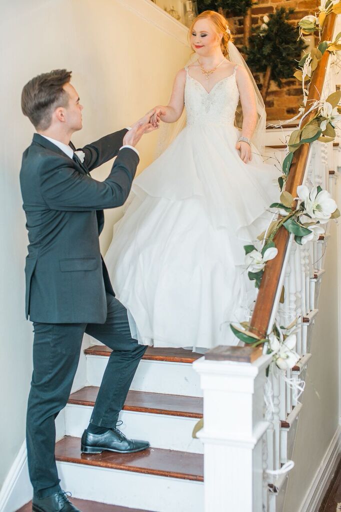 groom escorting madeline stuart down stairs