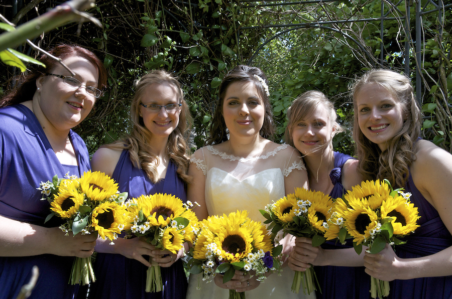 claire with bridesmaids holding sunflowers