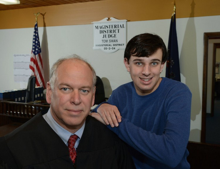 District judge Tom Swan and his autistic 19-year-old son, Kevin, inside the courtroom of his West Deer magistrate's office on Friday, Feb. 12, 2016.