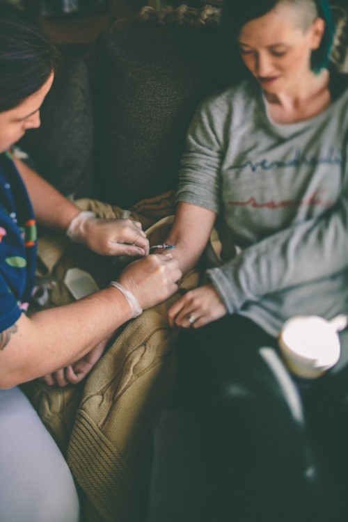 nurse giving a woman an injection in her arm