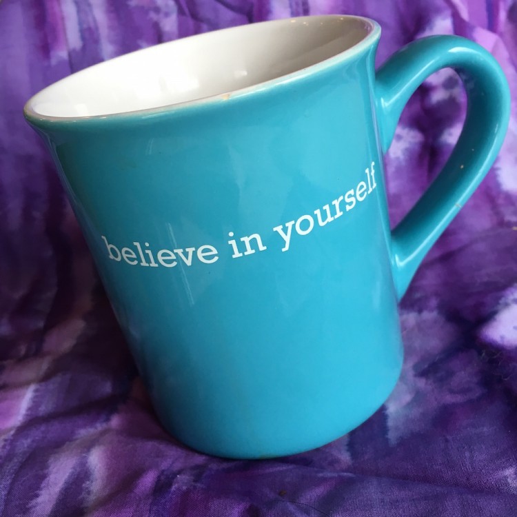 blue coffee mug with believe in yourself written in white