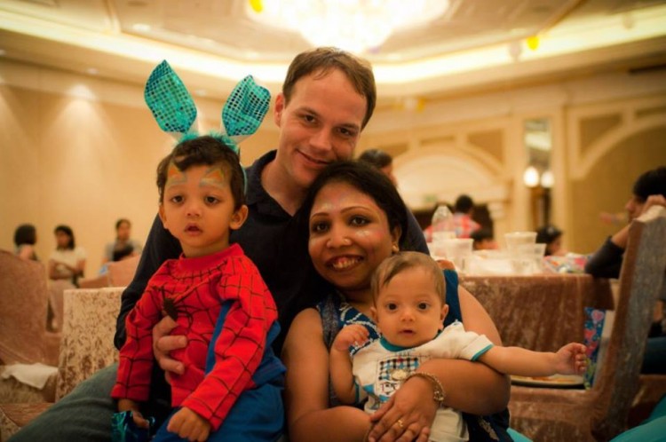 husband and wife with two young boys