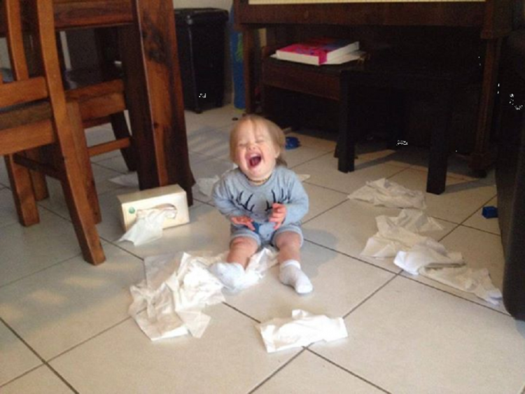 Boy with Down syndrome playing with tissues