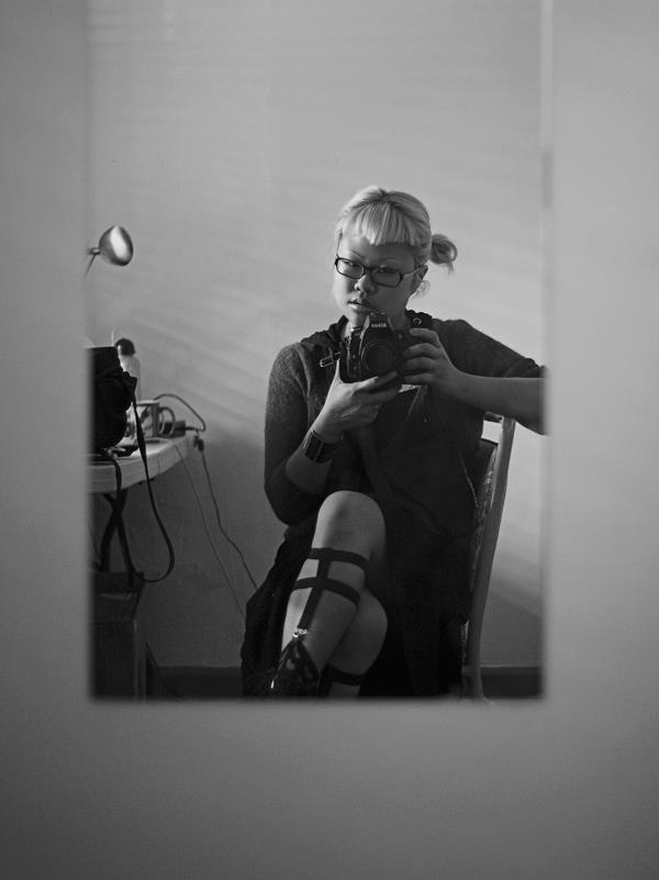 self portrait of photographer sitting facing mirror