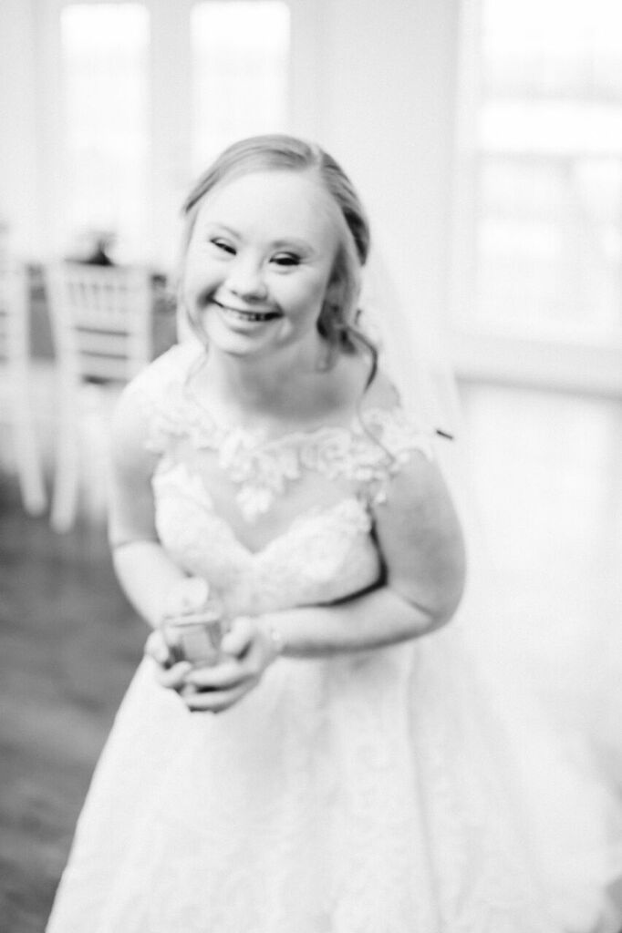 black and white photo, madline stuart smiling in wedding dress